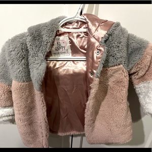 Girls fashionable faux fur coat. Never worn. Smoke free and pet free home.